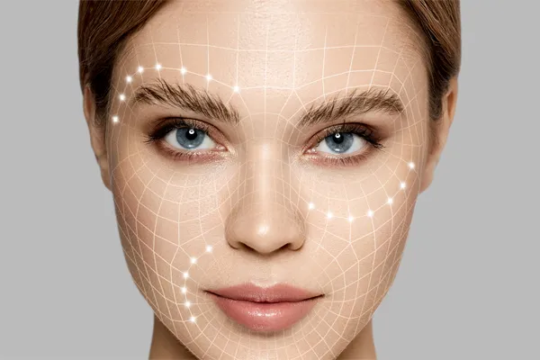 Close-up of a beautiful face against a gray background, with flowing gridlines illustrated along the cheeks, brow and lips, representing aesthetic filler services from Dr. Hadi Michael Rassael at Millennium Wellness in Bethesda-Chevy Chase.