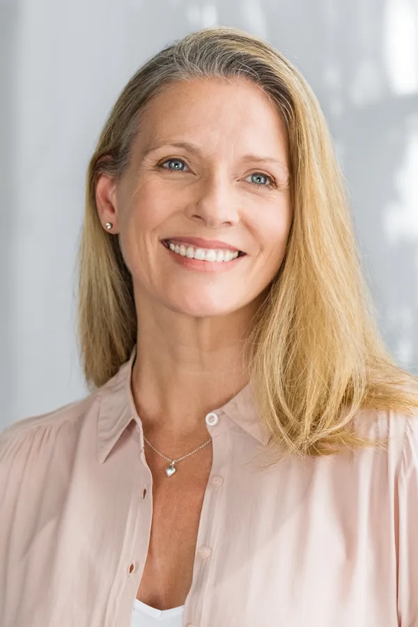 A mature blonde woman with a smooth brow. Get a brow lift from Dr. Hadi Michael Rassael at Millennium Wellness in Bethesda-Chevy Chase.
