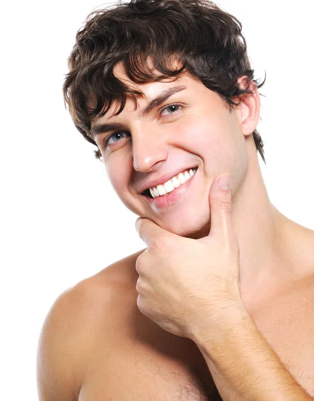 A man strokes his acne-free face. Get CLEARLight Acne Treatment from Dr. Hadi Michael Rassael at Millennium Wellness in Bethesda-Chevy Chase.