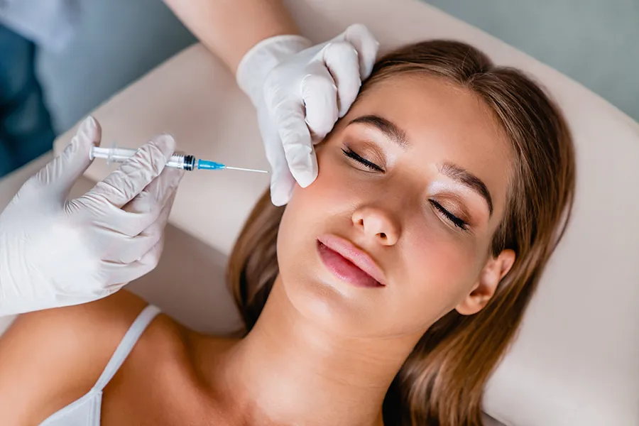 A woman receiving facial injections. Get Dysport facial injections from Dr. Hadi Michael Rassael at Millennium Wellness in Bethesda-Chevy Chase.