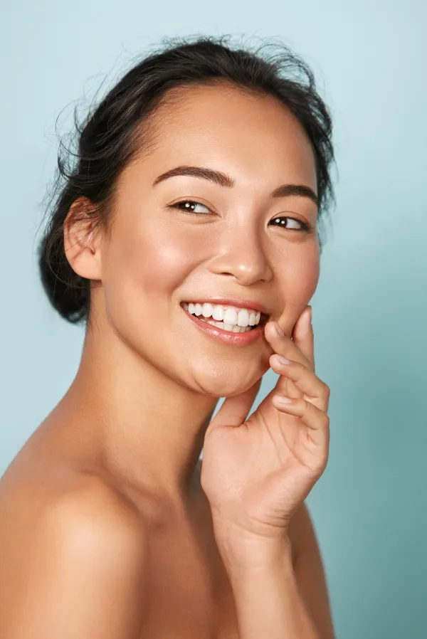 An asian woman with radiant skin. Get Dysport facial injections from Dr. Hadi Michael Rassael at Millennium Wellness in Bethesda-Chevy Chase.