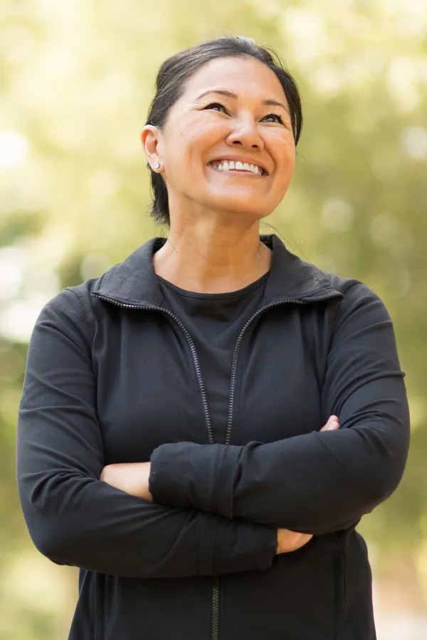 A middle-aged asian woman with a youthful face. Get facial liposuction from Dr. Hadi Michael Rassael at Millennium Wellness in Bethesda-Chevy Chase.