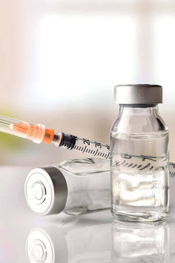 Close-up of vials with fluid and a syringe. Get Juvederm fillers from Dr. Hadi Michael Rassael at Millennium Wellness in Bethesda-Chevy Chase.
