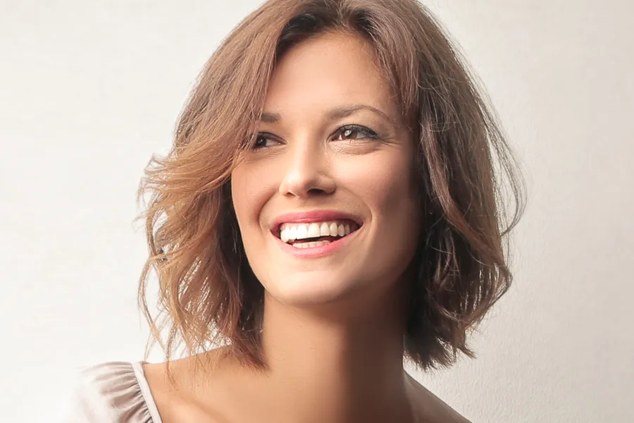 A middle-aged woman with youthful skin. Schedule laser skin tightening treatment from Dr. Hadi Michael Rassael at Millennium Wellness in Bethesda-Chevy Chase.