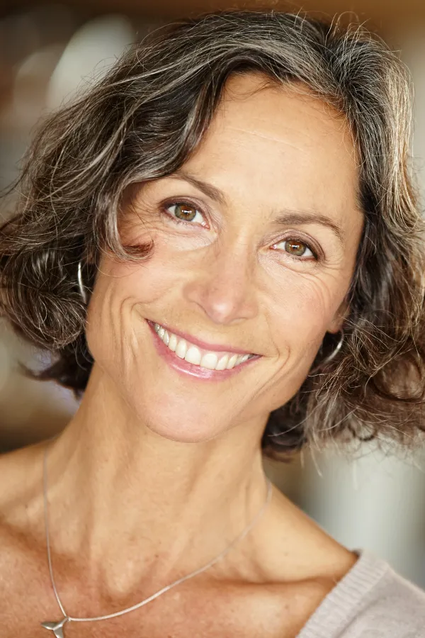 A mature woman with a youthful neck. Get a neck lift from Dr. Hadi Michael Rassael at Millennium Wellness in Bethesda-Chevy Chase.