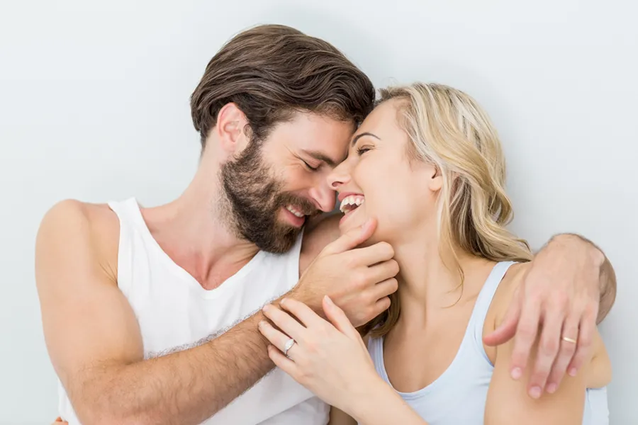 A joyful image of a couple playfully embracing each other. PRP for Erectile Dysfunction offered by Dr. Hadi Michael Rassael at Millennium Wellness in Bethesda-Chevy Chase.