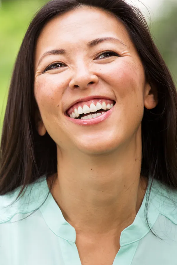 A beautiful asian woman with a smooth, tight face. Get Tempsure Envi RF for skin tightening from Dr. Hadi Michael Rassael at Millennium Wellness in Bethesda-Chevy Chase.